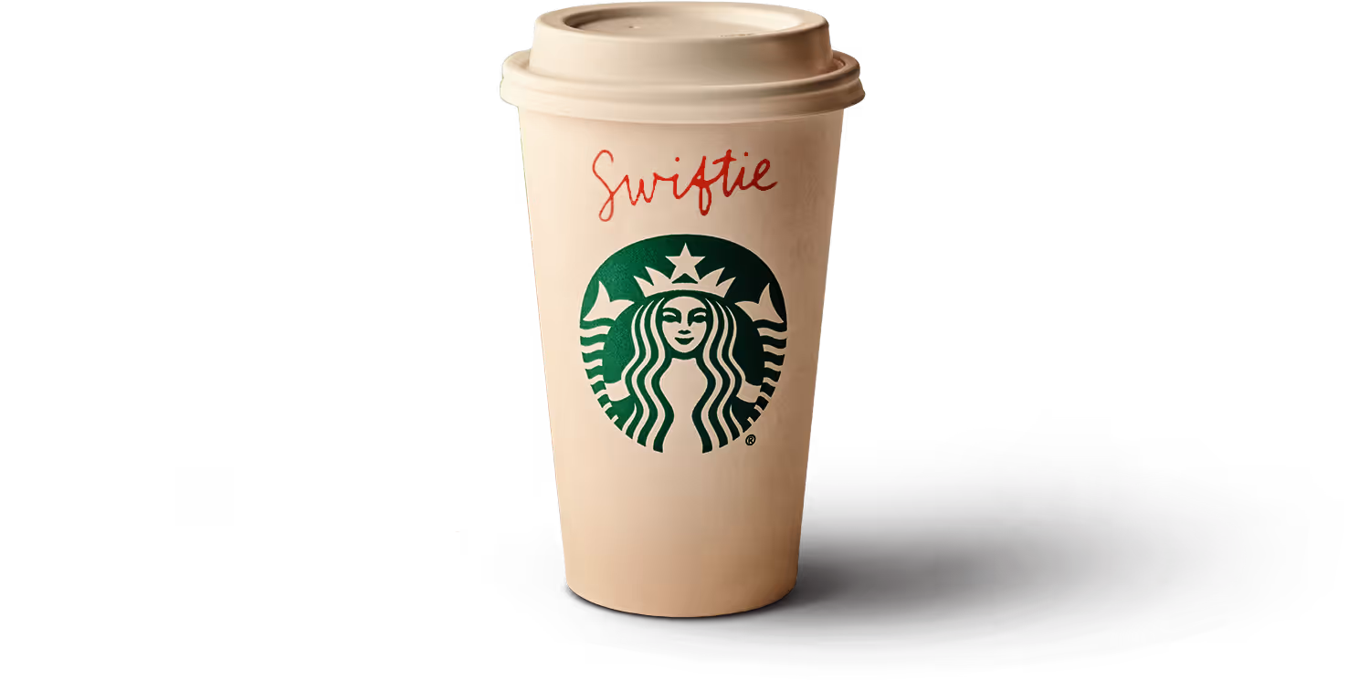 A plain Starbucks coffee cup with the name Swiftie written on the top side of the cup in red pen ink.